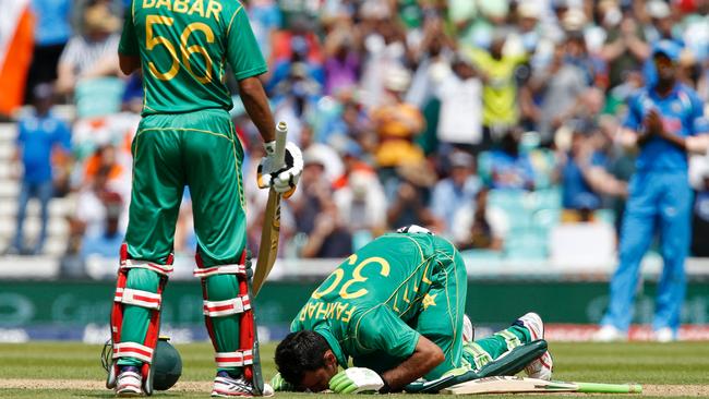 Pakistan's Fakhar Zaman falls to his knees and kisses the grass to celebrate his century.