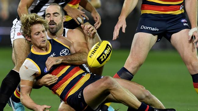 Rory Sloane is tackled by Steele Sidebottom during Friday night’s loss at Adelaide Oval.