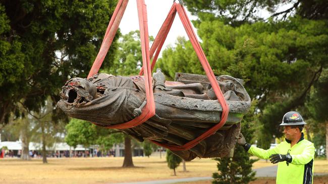 The damaged Queen Victoria statue in eastern gardens is craned away. Picture: Alison Wynd