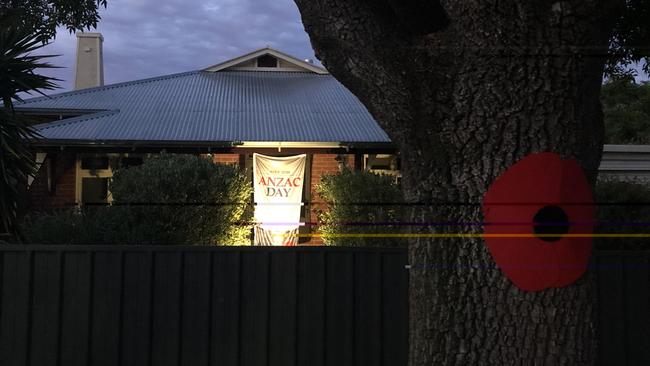 A poppy on a tree and Anzac banner outside a home in Colonel Light Gardens. Photo Jessica Leo-Kelton.