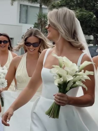 Robbie helps the bride with her train.