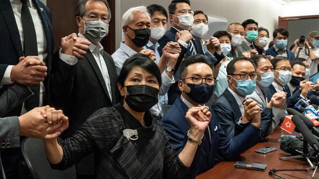 Pro-democracy MPs join hands in a display of unity at Hong Kong’s Legislative Council Building. Picture: Getty Images