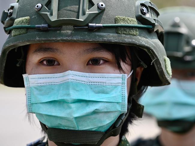 (FILES) In this file photo female soldiers wearing face masks amid the COVID-19 coronavirus pandemic stand in formation during Taiwan President Tsai Ing-wen's visit to a military base in Tainan, southern Taiwan, on April 9, 2020. - The United States on April 9, 2020 accused the World Health Organization of putting politics first by ignoring Taiwanese warnings over China's coronavirus outbreak, laying out its case against the UN body. President Donald Trump has threatened to withhold US funding for the WHO, which is at the forefront of fighting the pandemic that has infected more than 1.5 million people worldwide. (Photo by Sam Yeh / AFP)