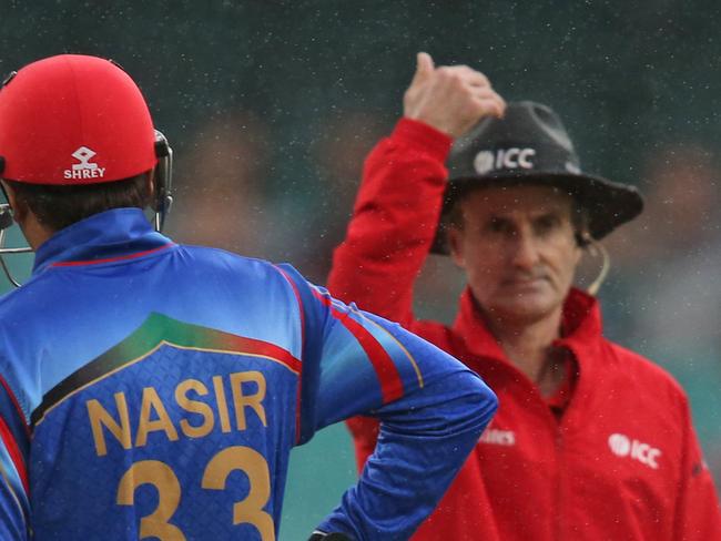 Umpire Billy Bowden gestures for the game to be temporarily called off as it rains, with Afghanistan’s Jamal Nasir standing beside him during the Cricket World Cup pool A match between Afghanistan and England in Sydney, Friday, March 13, 2015. (AP Photo/Rick Rycroft)