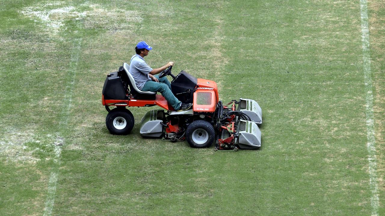 A groundsman cuts the grass at the 2014 soccer World Cup venue at the Arena da Amazonia in Manaus, Brazil, Wednesday, June 11, 2014. (AP Photo/Themba Hadebe)