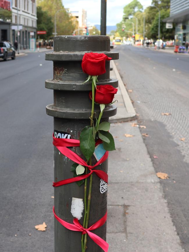 The husband of a woman killed on Grenfell St has laid roses at the site of the accident. Picture: Riley Walter