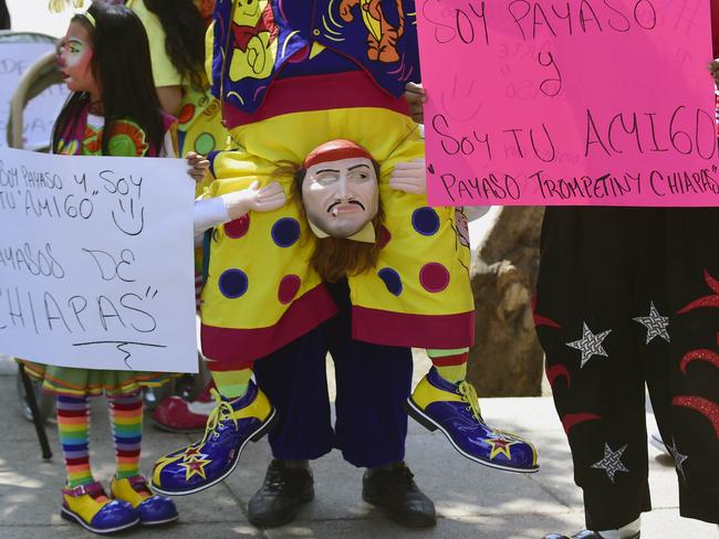 <!DOCTYPE html PUBLIC "-//W3C//DTD HTML 4.0 Transitional//EN" "http://www.w3.org/TR/REC-html40/loose.dtd"><html><body><p>A young girl clown and the legs of two clowns pose during the third day of the XXI Convention of Clowns, at the Jimenez Rueda Theatre, in Mexico City on October 19, 2016. Picture: AFP PHOTO / Alfredo ESTRELLA</p></body></html>