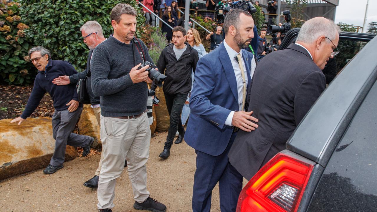 Trevor Sofield, the former high commissioner to Solomon Islands in the early 1980s, is brushed aside by the Prime Minister’s security team in Tasmania on Thursday. Picture: Jason Edwards