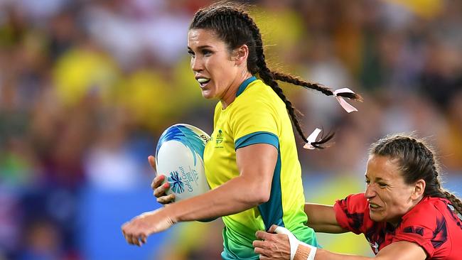 GOLD COAST, AUSTRALIA - APRIL 13:  Charlotte Caslick of Australia is tackled by Jasmine Joyce of Wales during the Rugby Sevens Women's Pool B match between Australia and Wales on day nine of the Gold Coast 2018 Commonwealth Games at Robina Stadium on April 13, 2018 on the Gold Coast, Australia. (Photo by Dan Mullan/Getty Images)