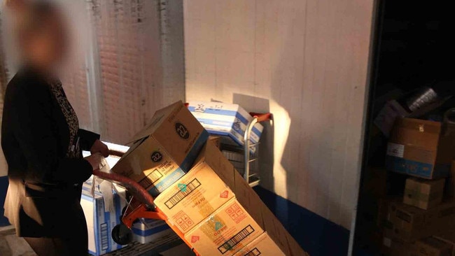 Police seize the infant formula tins. Picture: NSW Police