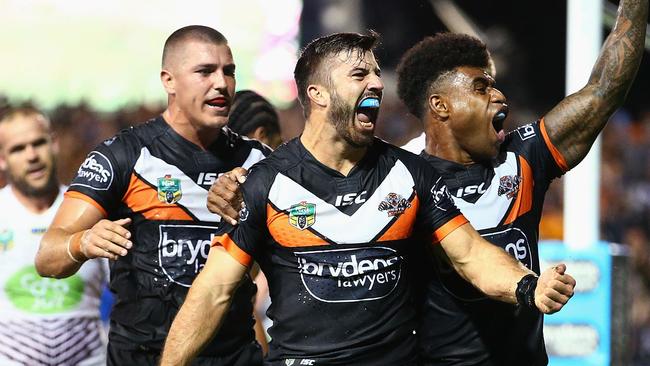 SYDNEY, AUSTRALIA - MARCH 14: James Tedesco of the Tigers celebrates his third try with team mates during the round two NRL match between the Wests Tigers and the Manly Sea Eagles at Leichhardt Oval on March 14, 2016 in Sydney, Australia. (Photo by Mark Nolan/Getty Images)