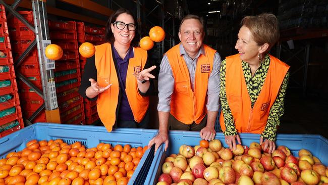 Foodbank Qld Exec officer Jess Watkinson Premier Steven Miles and Di Farmer at food bank in Morningside. Pic Annette Dew