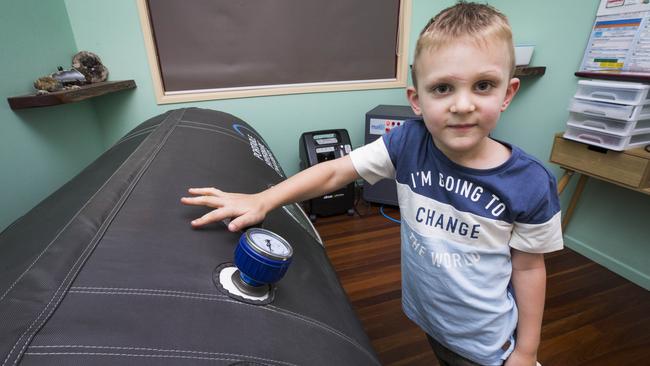 Eli Campbell with his portable hyperbaric chamber he uses as part of his ongoing treatment after suffering a near fatal snakebite at Agnes Waters. Picture: Lachie Millard