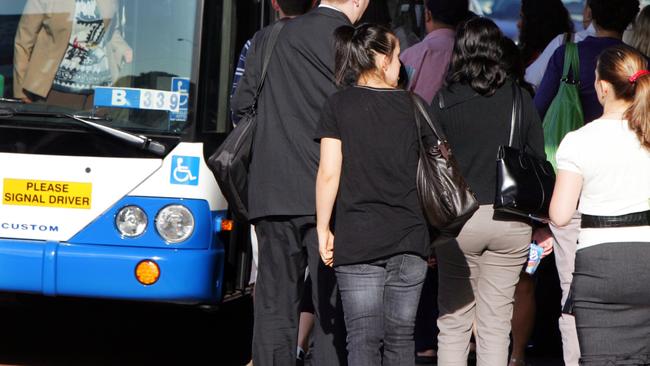 Commuters wait for a packed bus in Sydney.