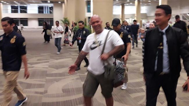 Finks bikie president Kosh Radford escorted back to a plane in Denpasar airport last week.