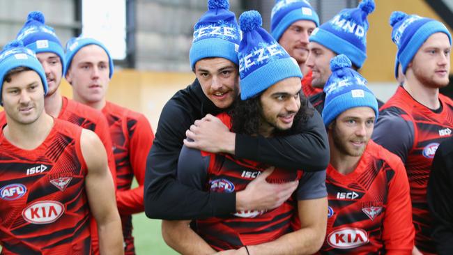 Joe Daniher hugs teammate Jake Long.