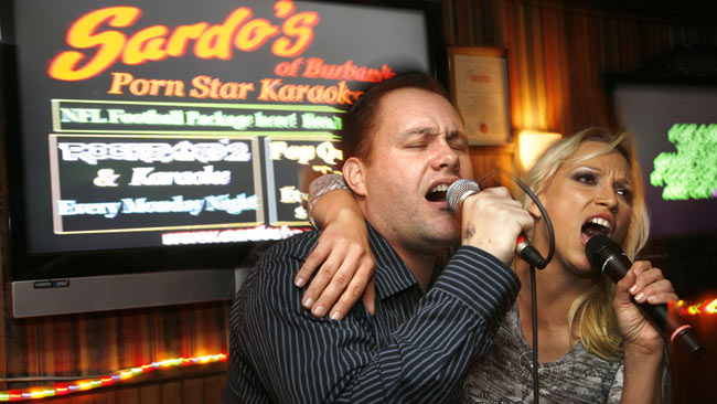 Daniel Hogan and Nicki Hunter sing together during Porn Star Karaoke