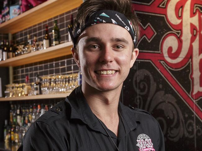 Westfield Knox Hog's Breath Cafe manager Matthew Rhodes (aka Styles) with a Hickory-Smoked Brisket Burger, and some Hog Tail Fries. 'Lebron' and 'Duke' are in the background. Westfield Knox Shopping Centre, Wantirna South, Melbourne. Thursday September 28th 2017. Photo: Daniel Pockett