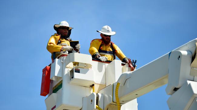 Ergon Energy crews out restoring power to Townsville suburbs after the floods.