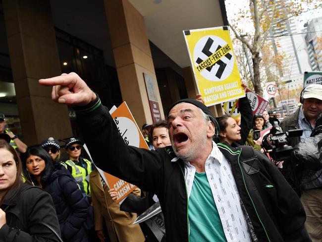 An anti-racism protester yells at UPF supporters. Picture: Jake Nowakowski