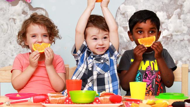 Jack Geneve-Clayer (centre) eats morning tea with his friends Vihaan Narahari and Lucy Wickham. Jack has egg, nut, soy and milk and dairy allergies. West end Community Childcare Centre has a strict no nut policy and requests that parents refrain from feeding their children nut products before attending the centre. Picture: Claudia Baxter