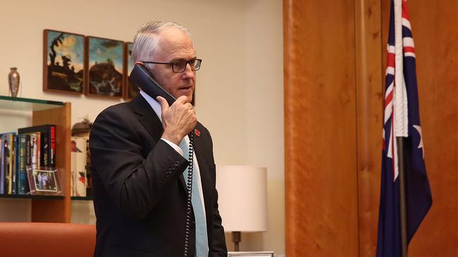 In this handout photo released and taken on November 10, 2016 by the prime ministers office shows Australian Prime Minister Malcolm Turnbull talking on the telephone to US President-elect Donald Trump in his office in Canberra. Trump is committed to enhancing US military power and maintaining its presence in Asia, Australia's prime minister said after 