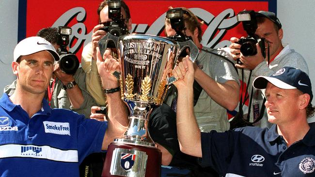 Wayne Carey and Craig Bradley holding AFL Premiership cup at the parade in 1999. Picture: HWT Library.