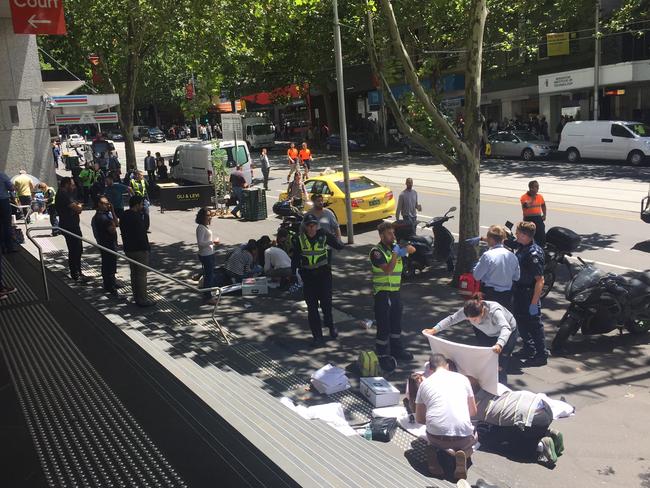 Paramedics and members of the public help people struck by the car. Picture: Supplied