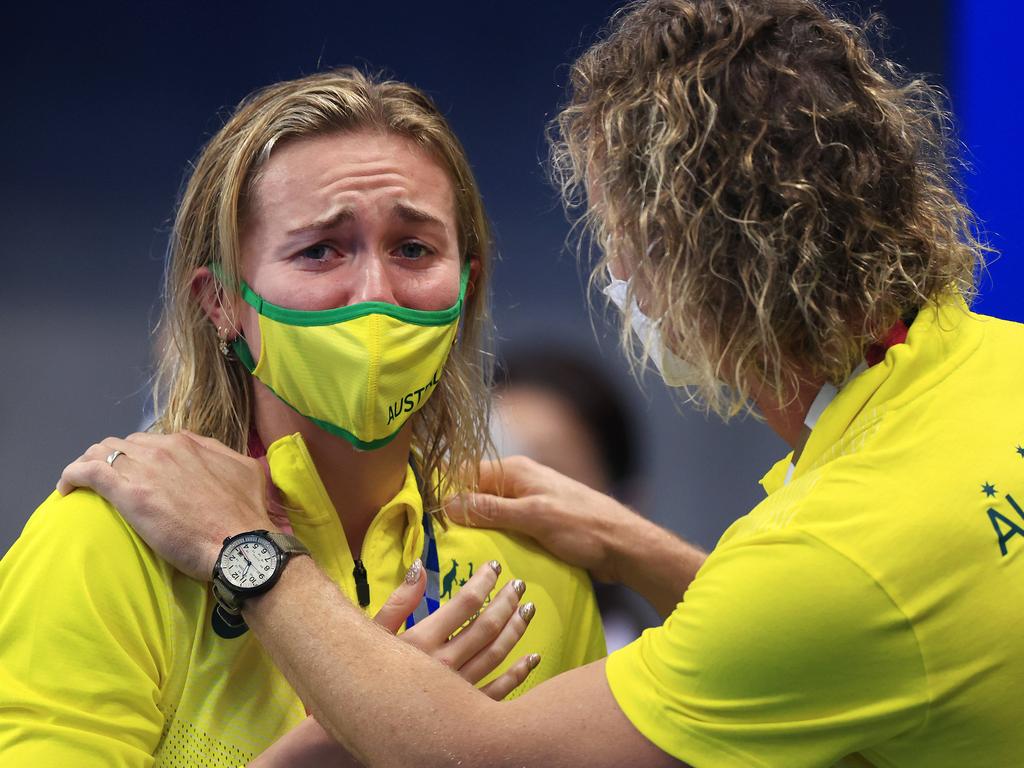 Ariarne Titmus is comforted by her coach Dean Boxall as she cries tears of relief and happiness after winning gold in the Women's 200m Freestyle. Picture: Adam Head