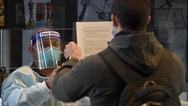 Healthcare staff run through a practice check-in. Picture: Andrew Henshaw