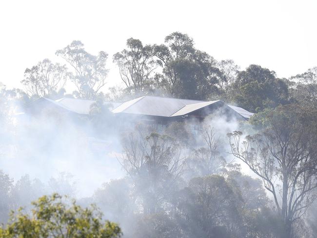 Fire burns perilously close to houses at The Gap. Picture: Annette Dew