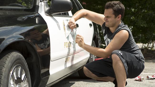 Ryan (Jake Johnson) acquires a police car in a scene from Let’s Be Cops. Picture: Supplied