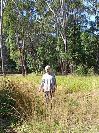 Russell Island resident Jan Schut says overgrown blocks around her home are a fire risk, but she has had significant trouble getting someone to clear the mess.