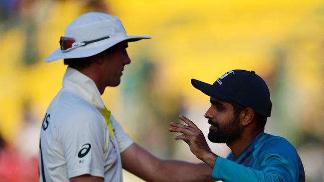 Cummins (L) speaks with Pakistan skipper Babar Azam after the drawn Test. Picture: AFP