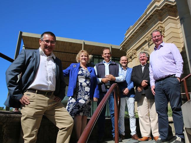 Drew Wickerson, Michelle Landry, Tony Williams, Grant Mathers, Neil Fisher, and Barry O'Rourke in front of the gallery.