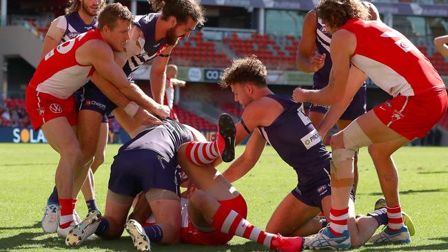 Lance Franklin is pounced on by unhappy Dockers. Picture: Kelly Defina/Getty Images