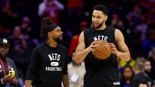 PHILADELPHIA, PENNSYLVANIA - MARCH 10:  Patty Mills #8 and Ben Simmons #10 of the Brooklyn Nets take the court for warm ups before the game against the Philadelphia 76ers at Wells Fargo Center on March 10, 2022 in Philadelphia, Pennsylvania. NOTE TO USER: User expressly acknowledges and agrees that, by downloading and or using this photograph, User is consenting to the terms and conditions of the Getty Images License Agreement. (Photo by Elsa/Getty Images)