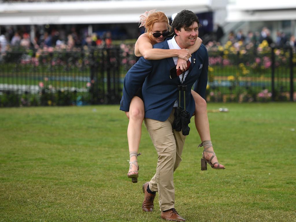 Racegoers are seen at the end of the Lexus Melbourne Cup Day, as part of the Melbourne Cup Carnival, at Flemington Racecourse in Melbourne, Tuesday, November 6, 2018. (AAP Image/Dan Himbrechts) NO ARCHIVING, EDITORIAL USE ONLY