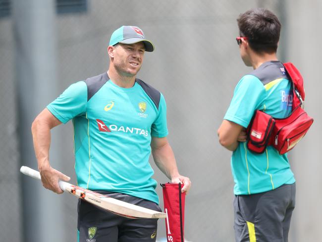 Australian team physio David Beakley and David Warner in the nets.