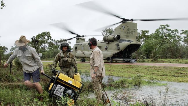 Mr Scott and Tim Broodbank from Telstra Service provide generator support to the town of Ingham during the North Queensland floods in 2025. Picture: Supplied