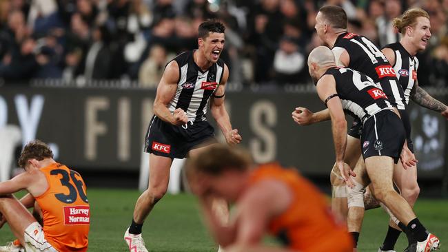 Scott Pendlebury, Darcy Cameron and Steele Sidebottom celebrate on the final siren. Picture: Michael Klein