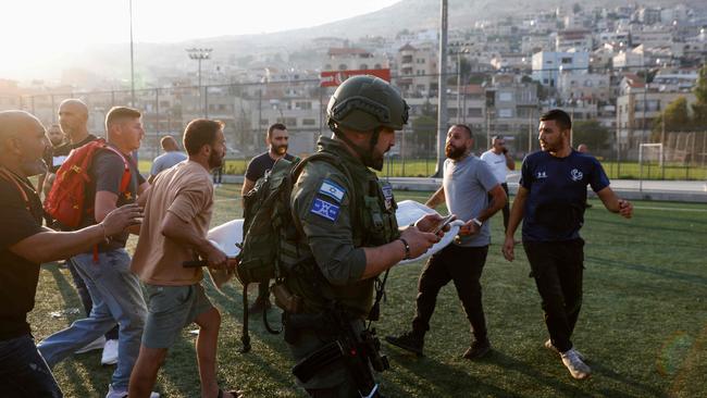 Israeli security forces and medics transport casualties from a site where a reported strike from Lebanon fell in Majdal Shams village in the Israeli-annexed Golan area. Picture: AFP