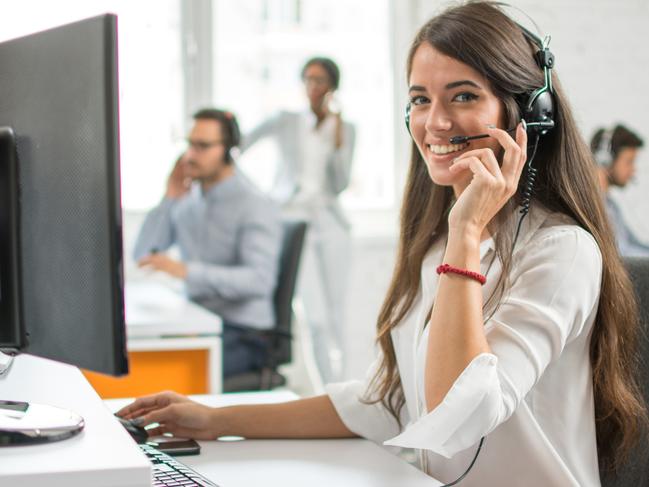 Young friendly operator woman agent with headsets working in a call centre. Administration. iStock