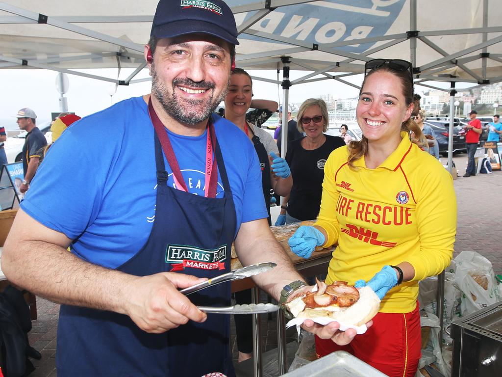 George Sabados and Anna Darby serving up democracy sausages in Bondi. Photo: Bob Barker