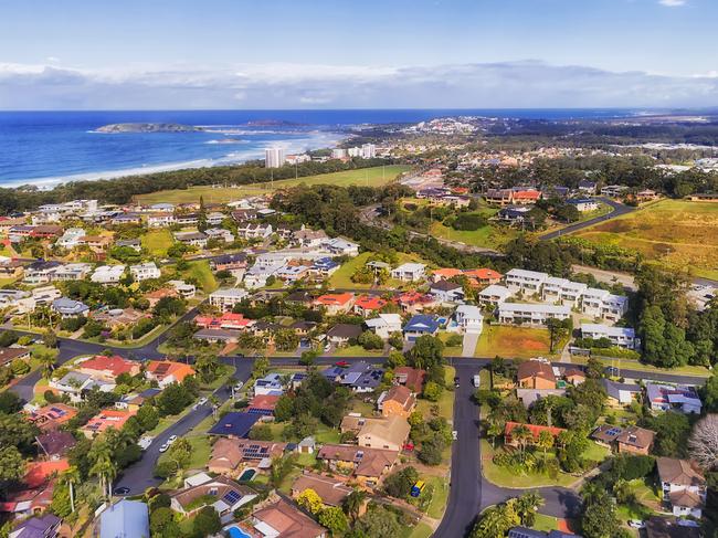 Coffs Harbour town streets, roads and suburbs on Australian pacific coast at the centre of banana industry with famous The Big Banana - aerial view towards distant town marina, port and Muttonbird island.Escape 14 janurary 2024DestinationsPhoto - iStock