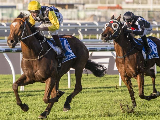 Jockey Hugh Bowman and Clearly Innocent surge past Jungle Edge (right) to easily win the Group 1 Kingsford Smith Cup.