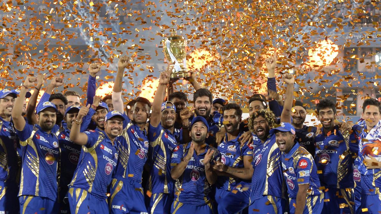 Mumbai Indians players hold the trophy after winning the 2017 IPL tournament. 