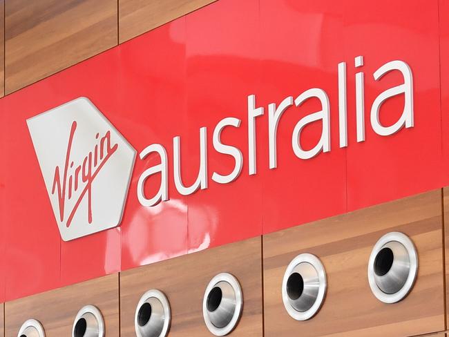 A queue can be seen at the Virgin Australia check in area during their nationwide computer outage at Adelaide Airport, Sunday, October 1 , 2017. (AAP Image/Morgan Sette) NO ARCHIVING