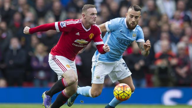 Manchester United's Wayne Rooney fights for the ball against Nicolas Otamendi of Manchester City.