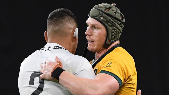 Australia's flanker David Pocock (R) hugs Fiji's hooker Samuel Matavesi after victory during the Japan 2019 Rugby World Cup Pool D match between Australia and Fiji at the Sapporo Dome in Sapporo on September 21, 2019. (Photo by WILLIAM WEST / AFP)